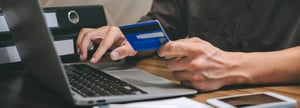 A person using accounting automation to pay a bill online with a credit card.