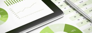 A financial professional is using accounting automation on a tablet.
