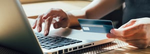 A person is entering credit card information to compete a B2B transaction.