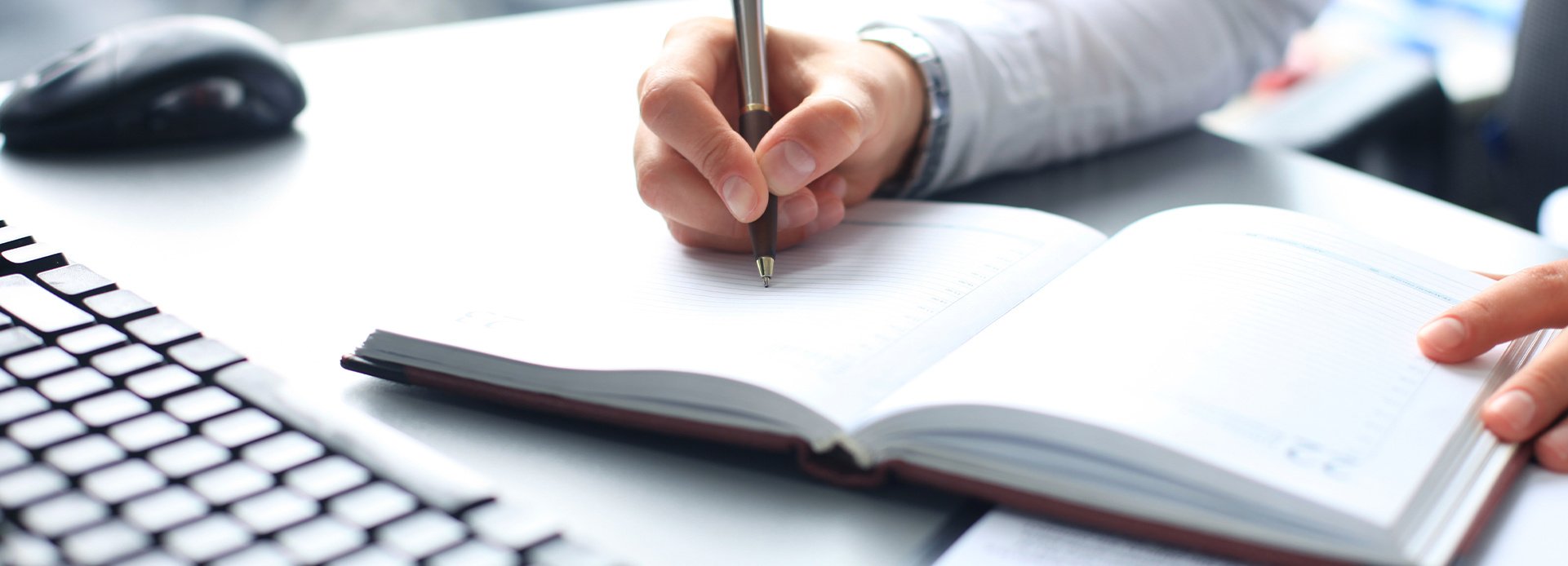 Businessman makes a note in notebook